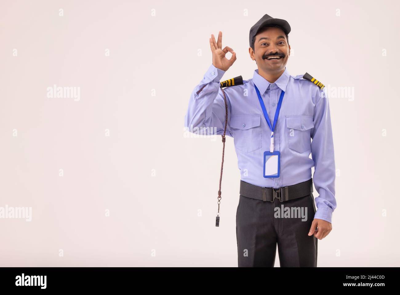 Portrait of security guard gesturing with his fingers Stock Photo