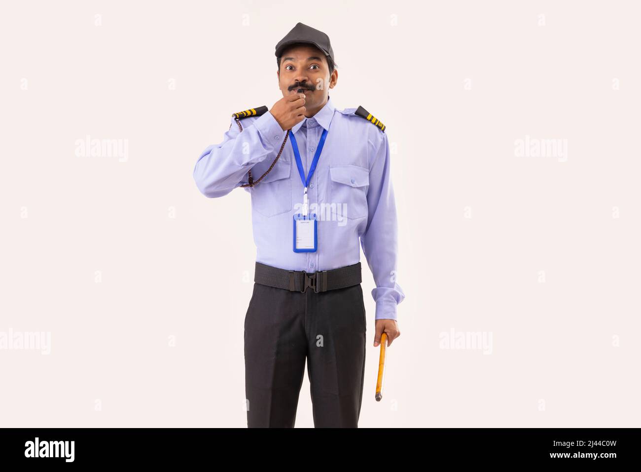 Portrait of Security guard blowing whistle Stock Photo