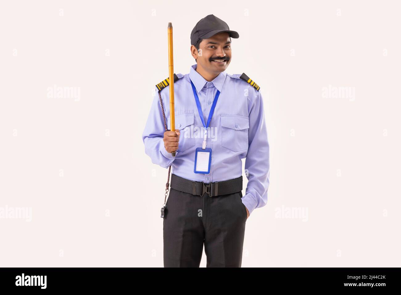 Portrait of Security guard standing with stick in his hand Stock Photo