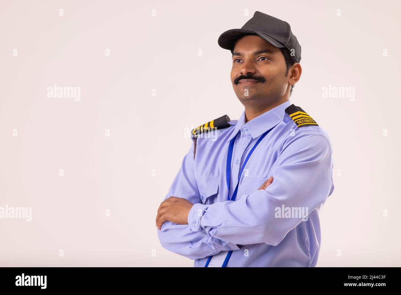 Portrait of Security guard looking elsewhere with arms folded Stock Photo