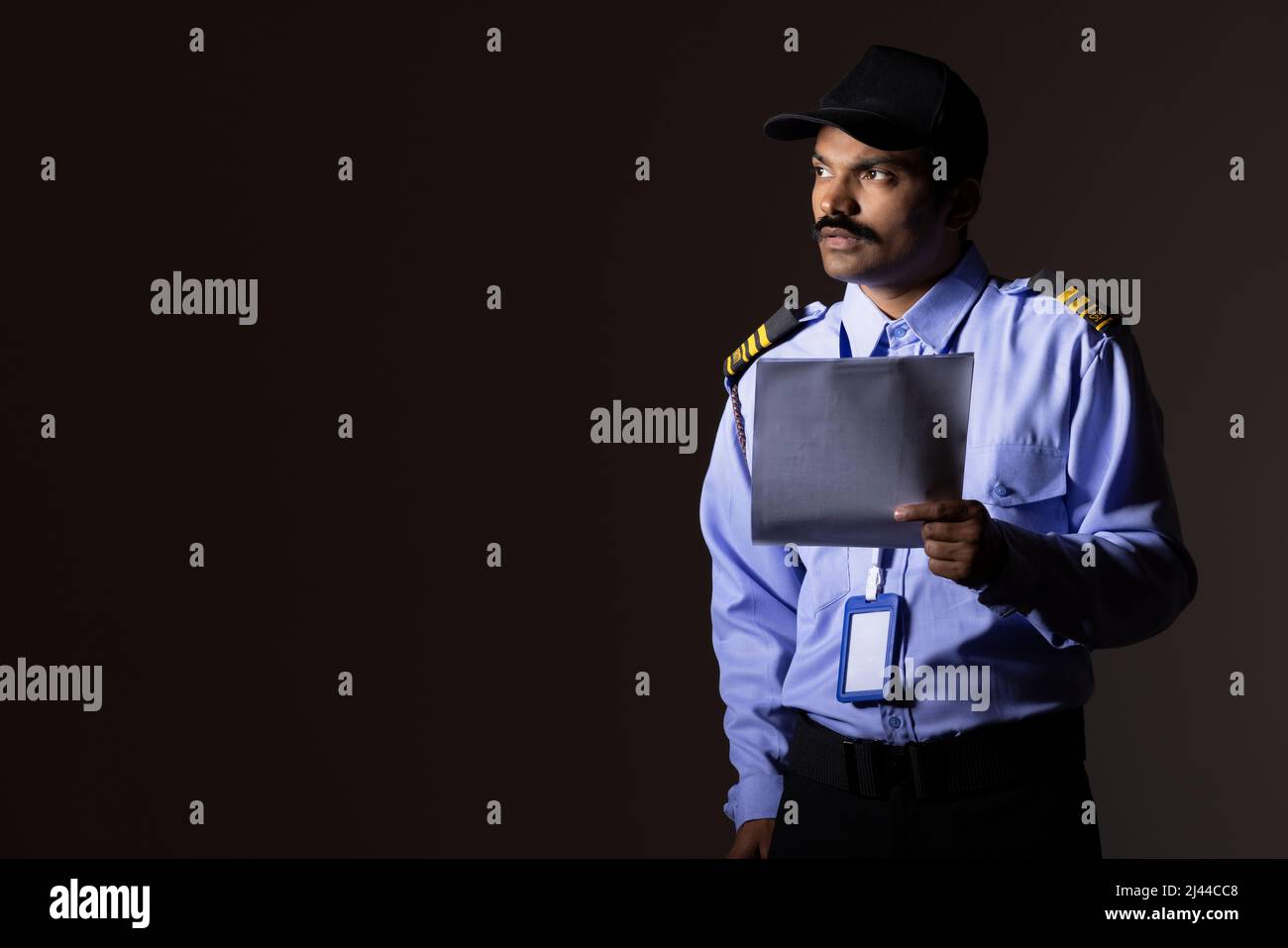 Security guard observing away while working at night Stock Photo