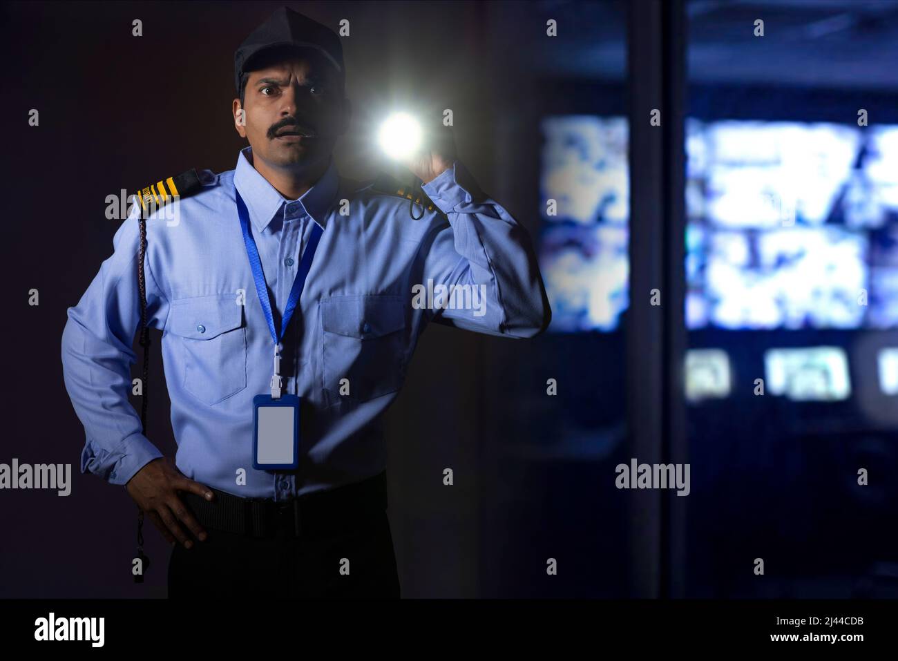 Security guard searching with torch light while working at night Stock Photo