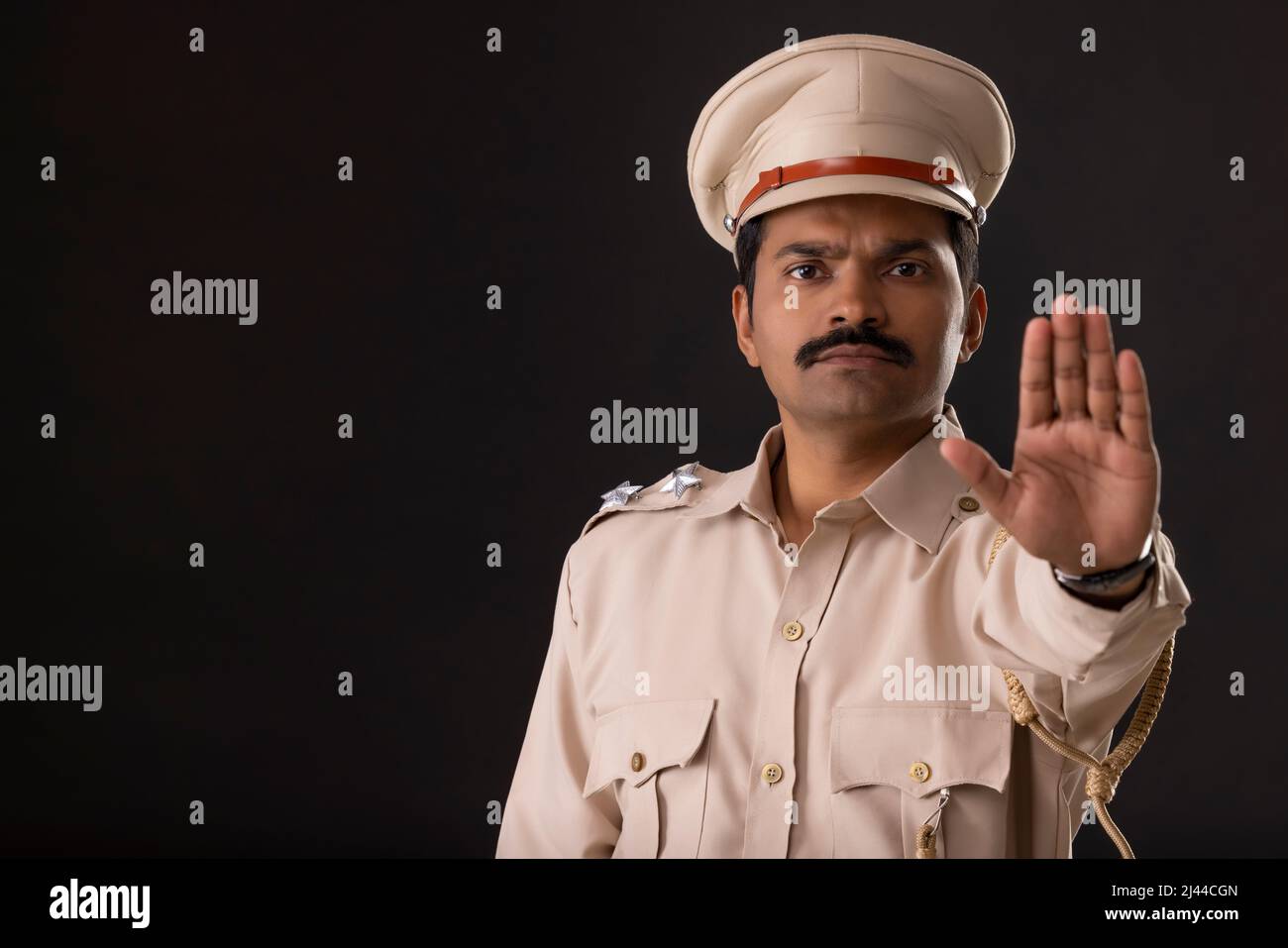 Close-up portrait of an Indian policeman gesturing with palm Stock Photo