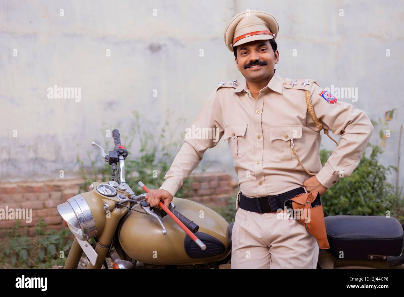 Portrait of an Indian policeman posing with bike Stock Photo