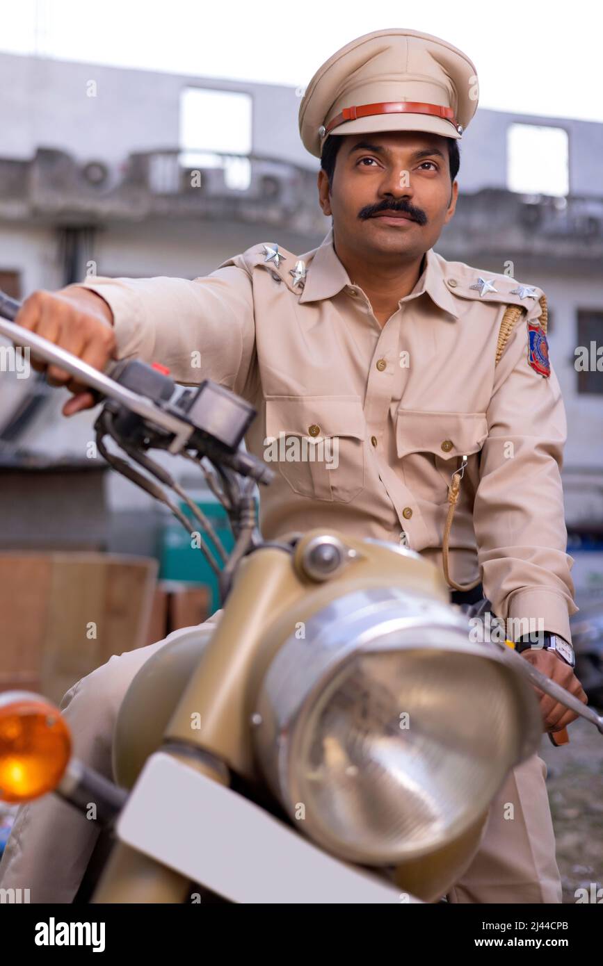 Portrait of an Indian policeman on bike Stock Photo