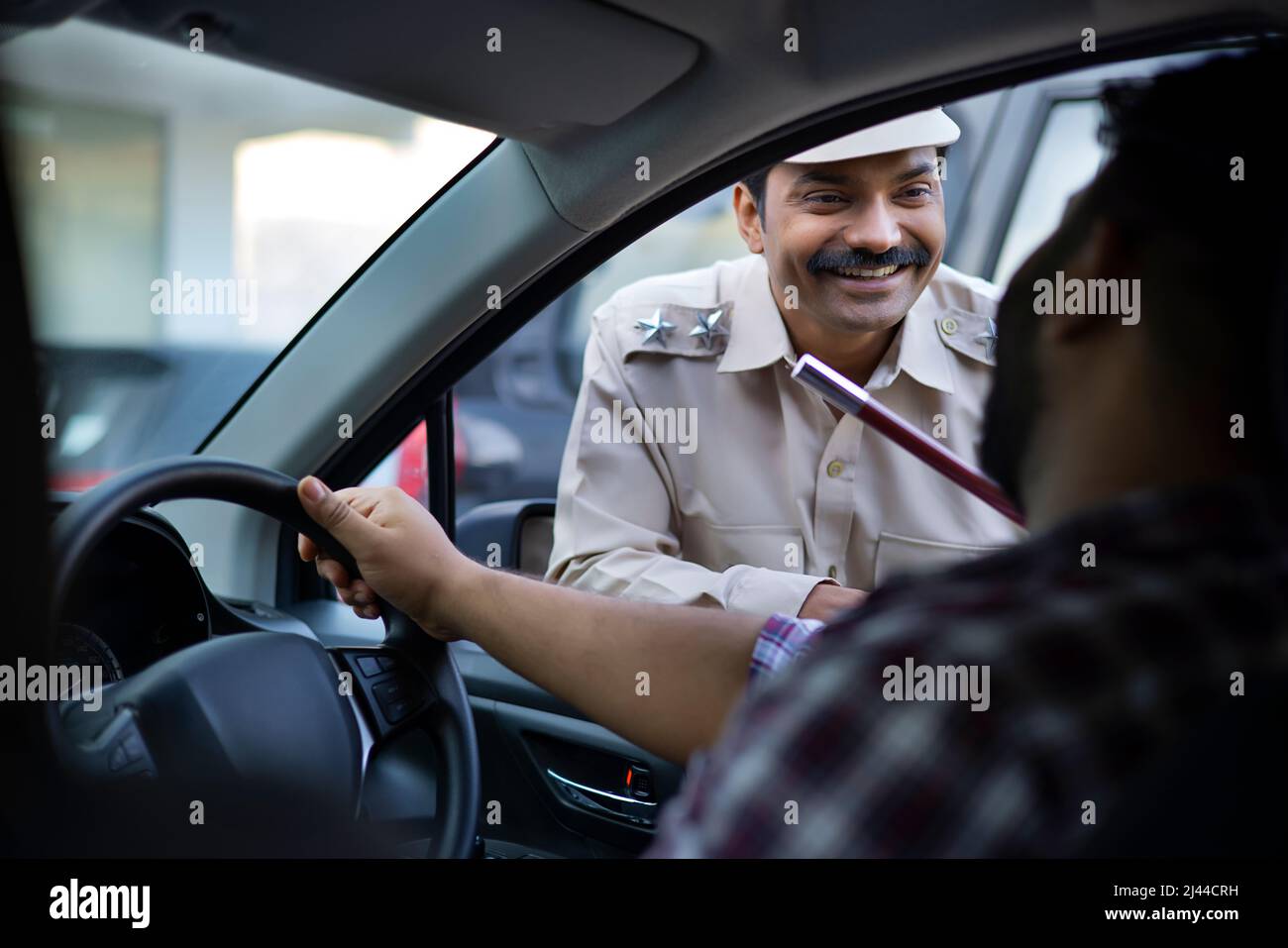 Portrait of an Indian policeman talking with car driver Stock Photo