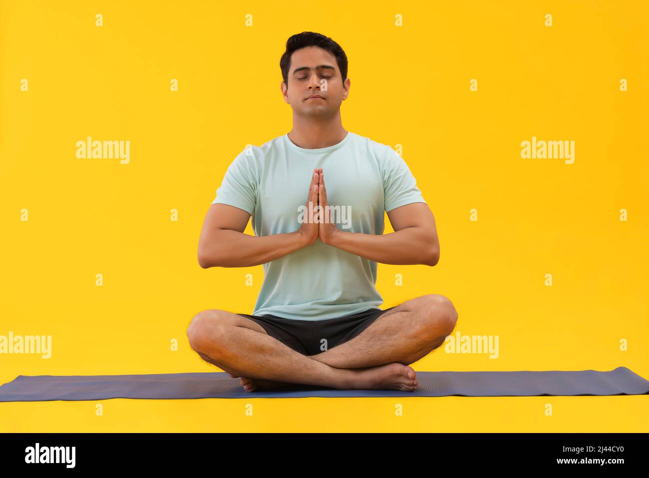 Portrait of a young man doing breathing exercise at home Stock Photo