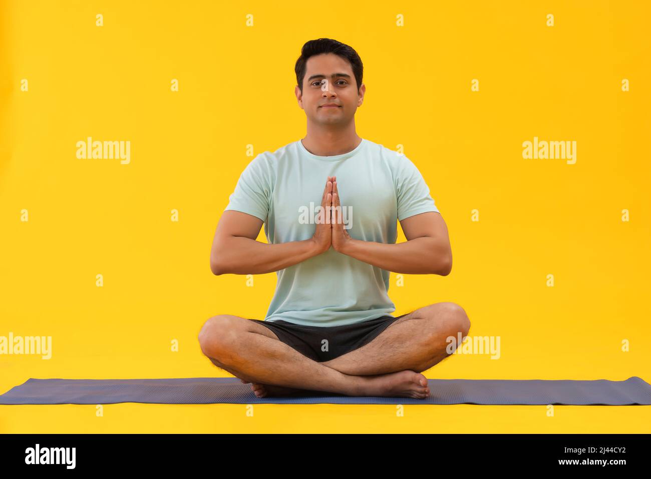 Portrait of a young man doing breathing exercise at home Stock Photo