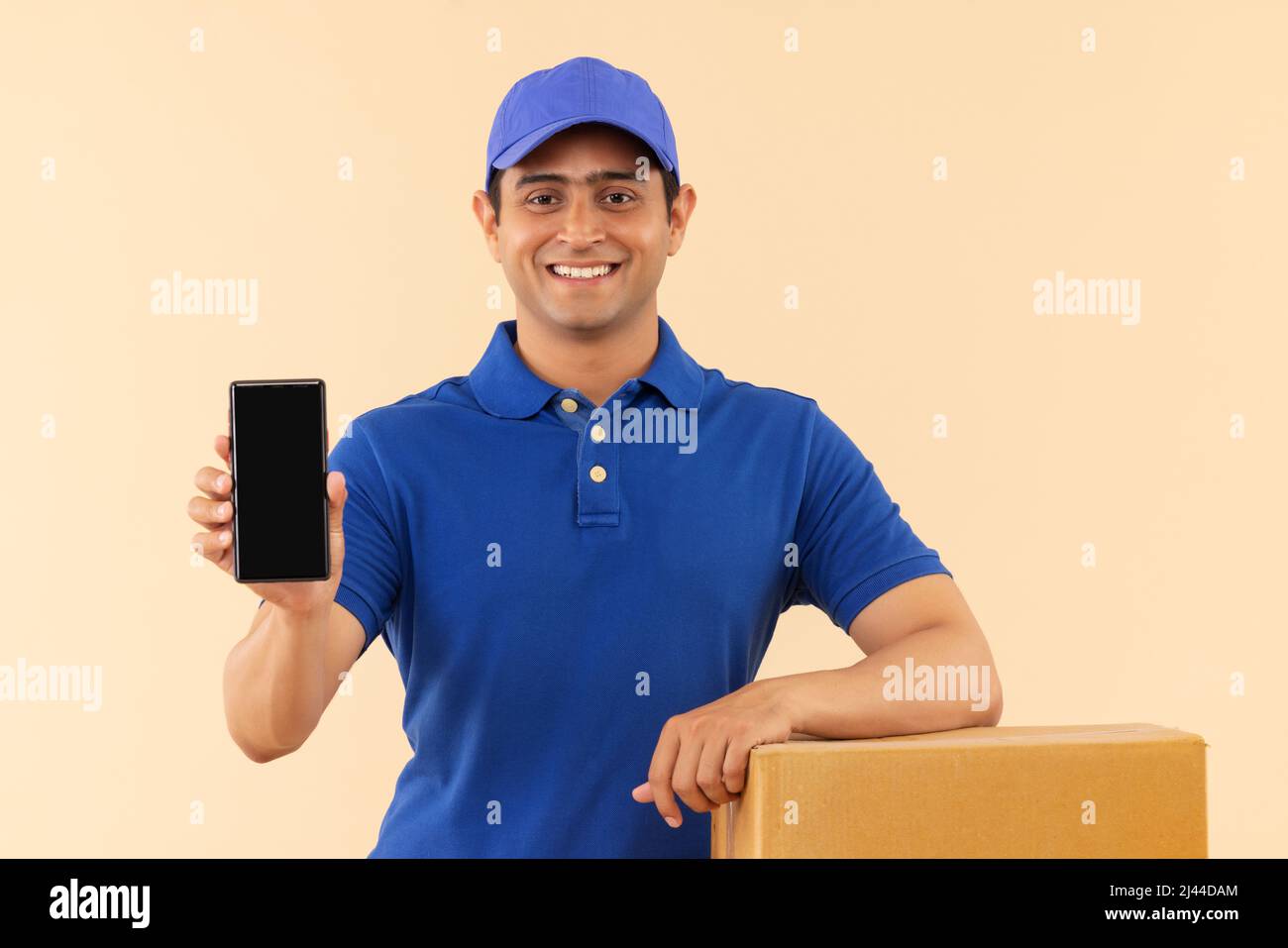 Portrait of a courier delivery boy showing Smartphone Stock Photo