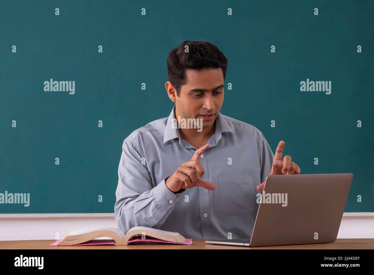 School teacher conducting an online class by using laptop Stock Photo