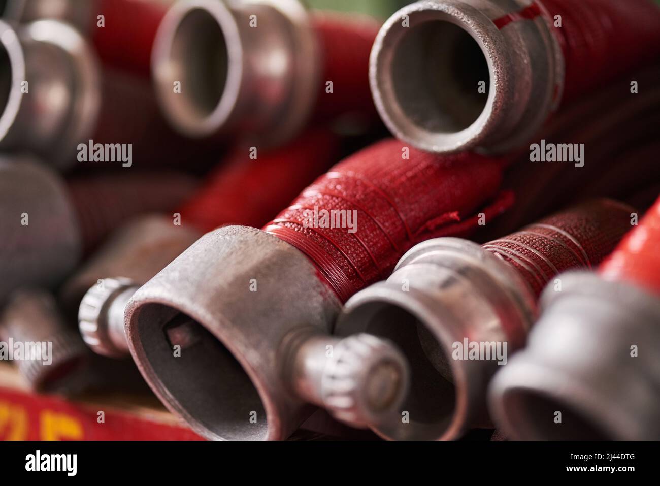 Ready to tackle any flame. Cropped shot of coiled fire hoses Stock