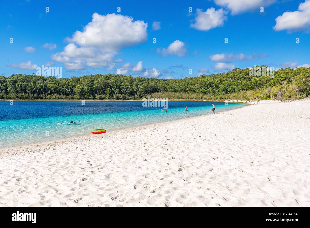 Tourists enjoying the crystal clear water at Lake McKenzie on Fraser Island in Queensland, Australia Stock Photo