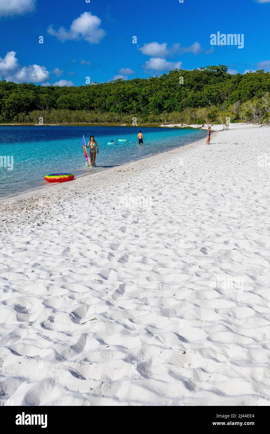 Tourists swim in the crystal clear water at Lake McKenzie on Fraser