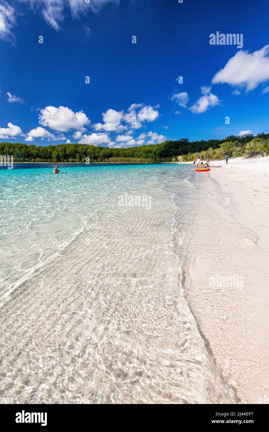Tourists swim in the crystal clear water at Lake McKenzie on Fraser