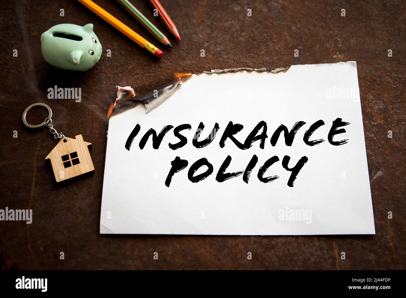 Insurance Policy concept. Burning sheet of paper with text Stock Photo