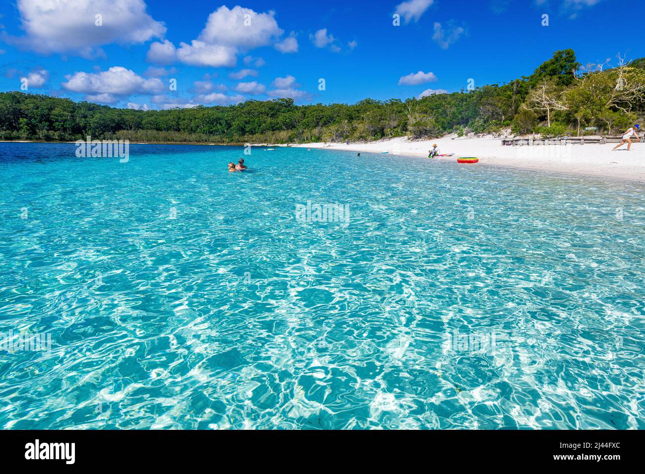 Tourists swim in the crystal clear water at Lake McKenzie on Fraser