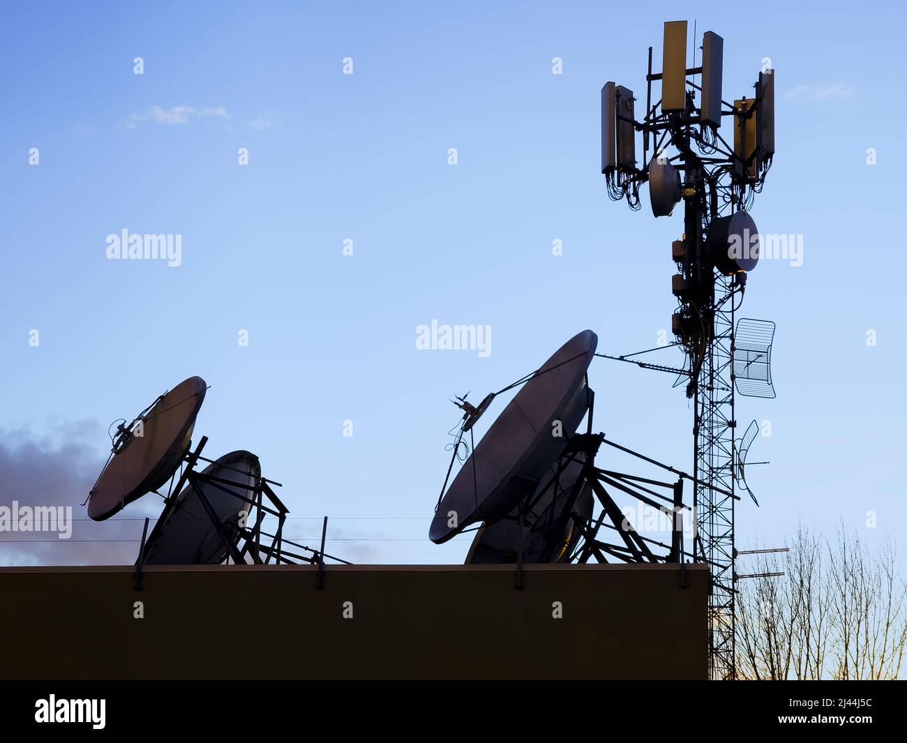 satellite dishes and relay installations on a pole against the
