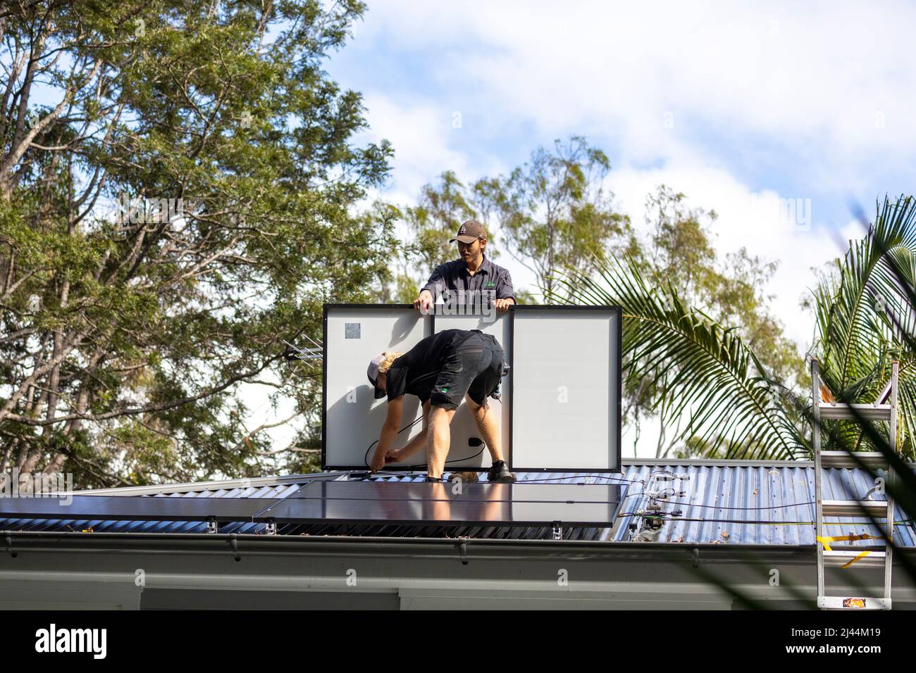 Solar PV panels installation on a Sydney home as two male installers