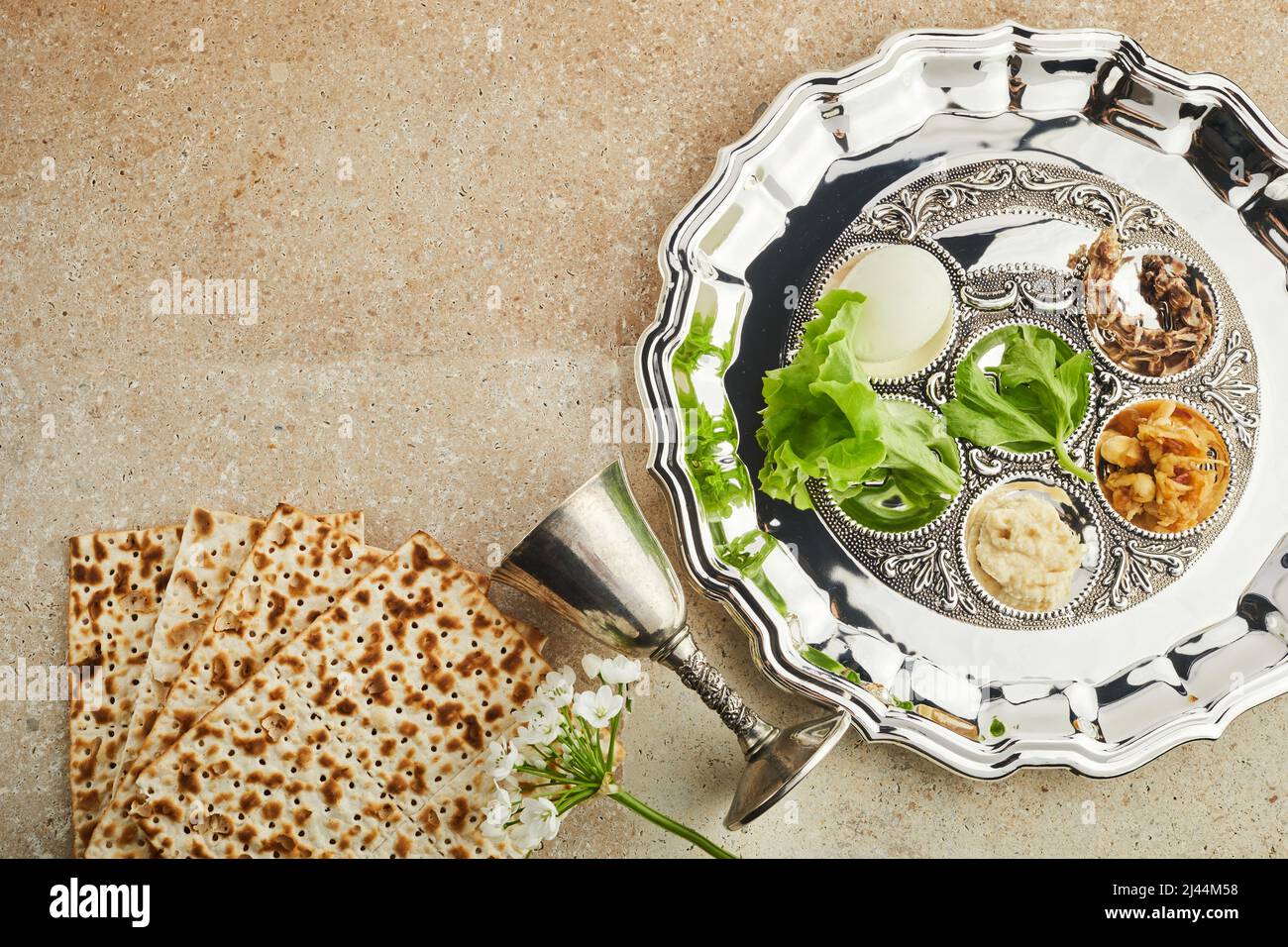 Passover Seder plate with traditional food ontravertine stone background Stock Photo