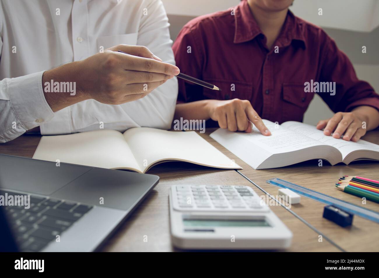 Teenager studying at desk and doing homeworks Stock Photo - Alamy