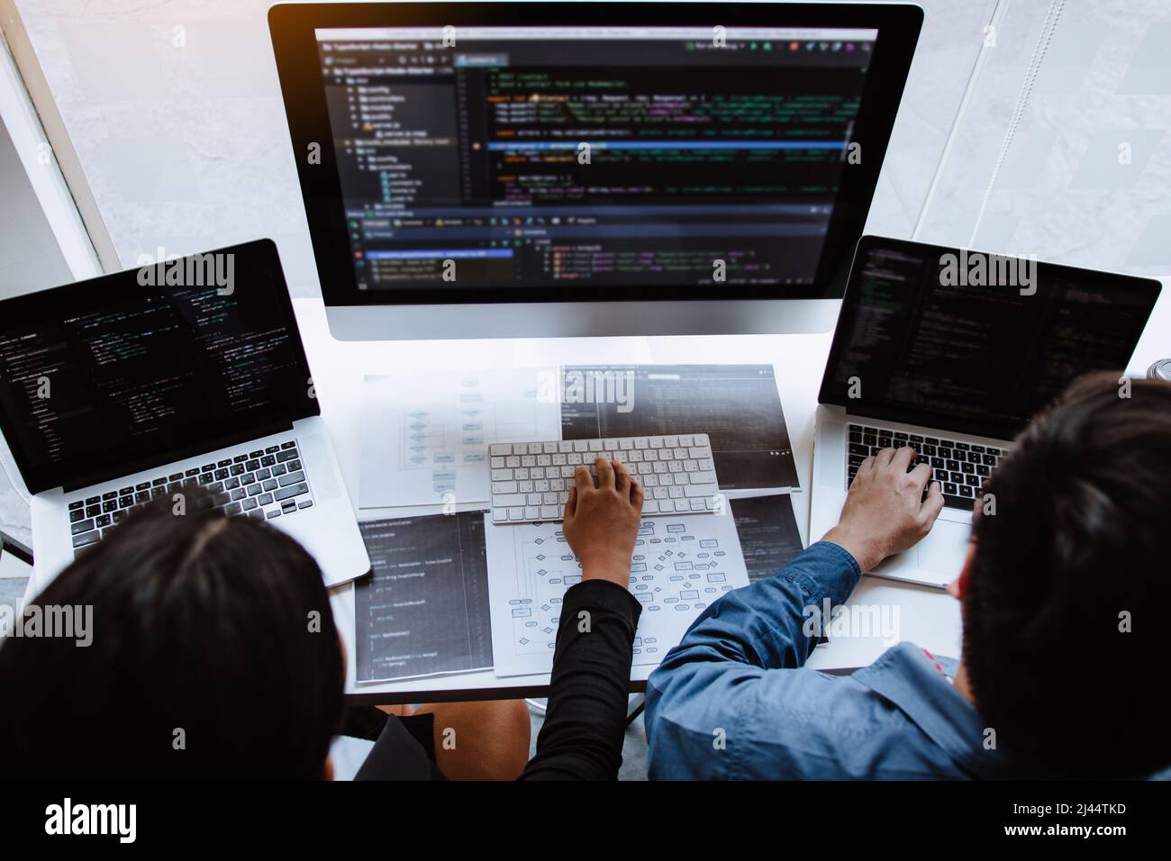 Professional development programmer cooperating meeting programming website working a software in office room. Stock Photo