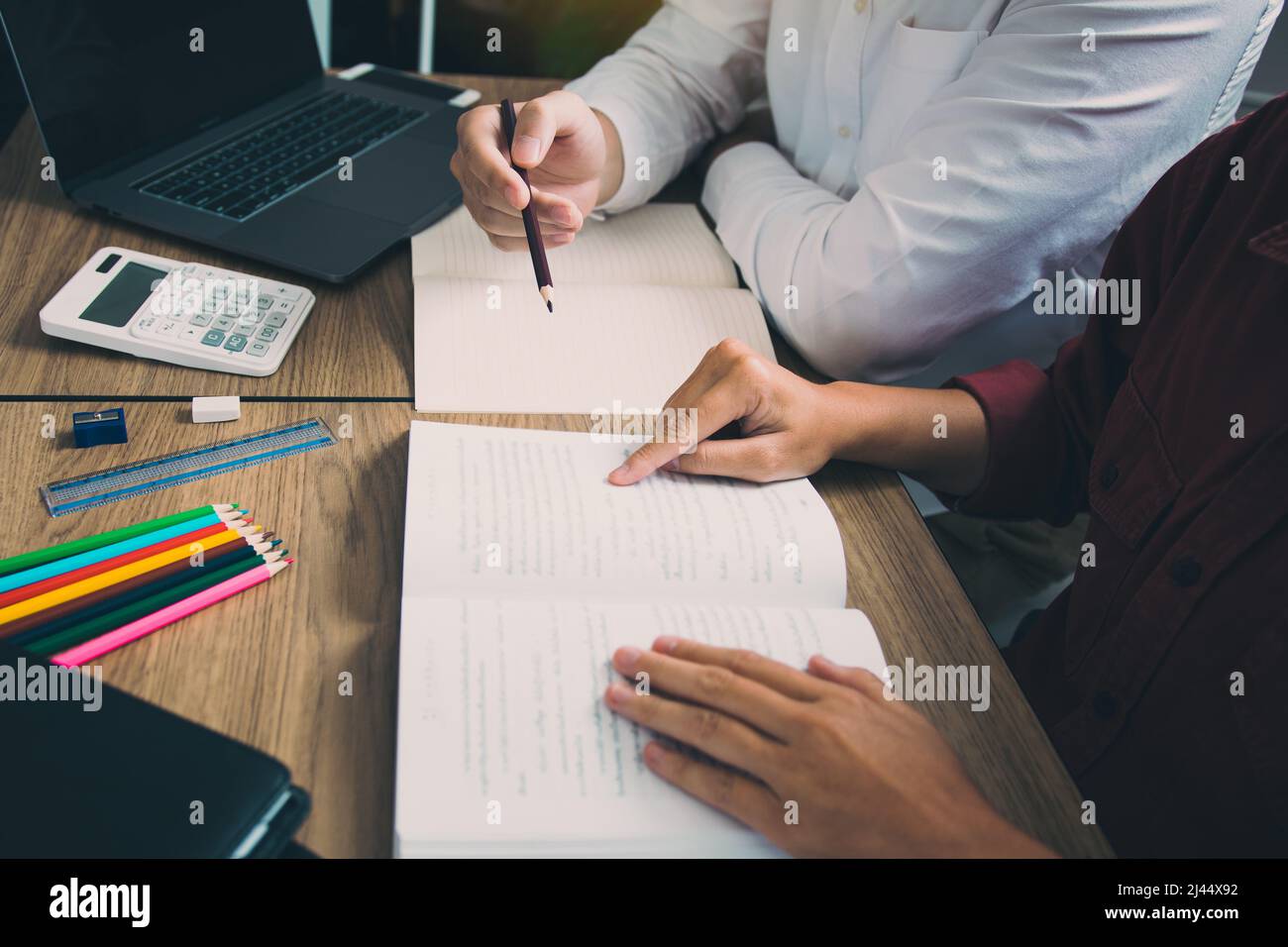Teenager studying at desk and doing homeworks Stock Photo - Alamy
