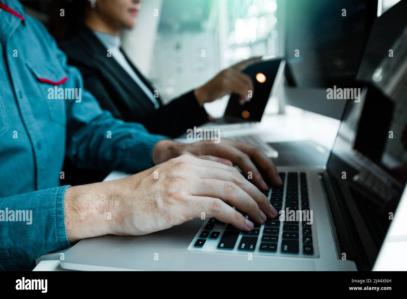 Developing programming and coding technologies working in a software engineers developing applications together in office. Stock Photo