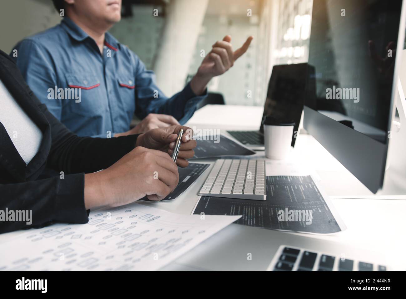Two asian team working development of programming and encryption technology website design programmers on desk in office. Stock Photo