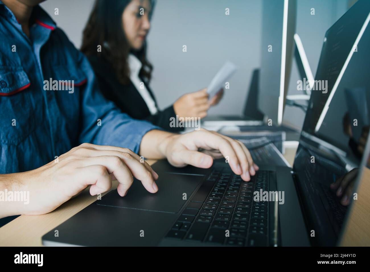 Two partnerships developing programming and coding technologies working on laptop and analyzing together. Stock Photo