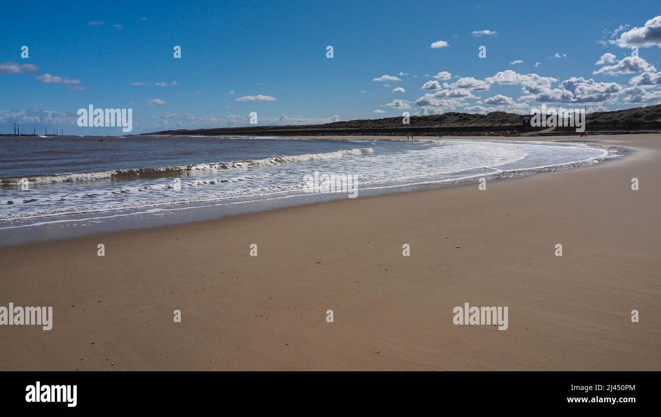 Waves rolling up the smooth sandy beach of the bay, Sea Palling, Norfolk, UK Stock Photo