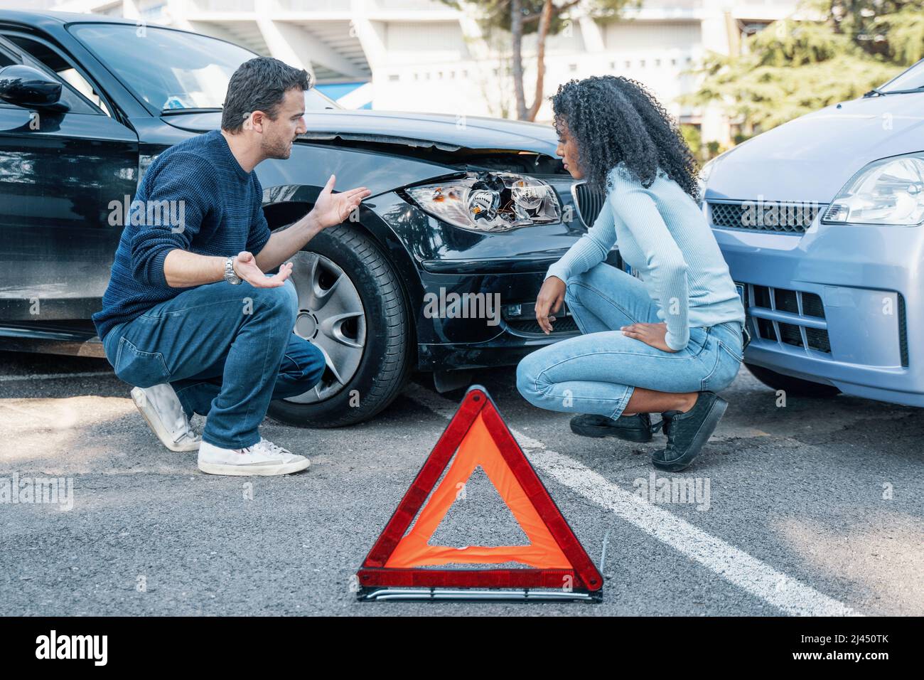 Two people arguing after a car accident argue Stock Photo