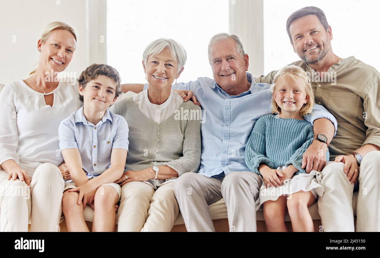 Awesome family fun. Shot of a beautiful family bonding on the sofa at home. Stock Photo