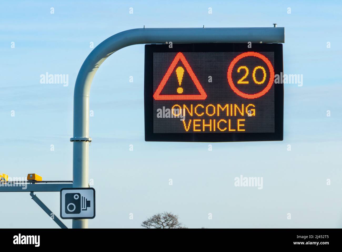 warning matrix sign on gantry with oncoming vehicle and 20 mph sign on M6 uk motorway Stock Photo
