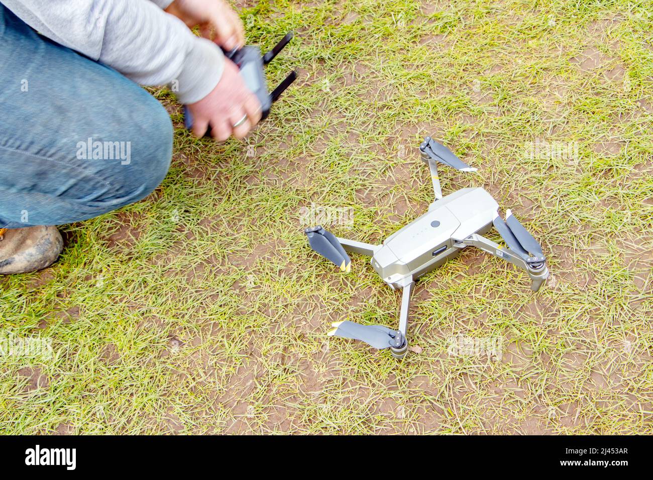 young man flying and controlling DJI magic drone Stock Photo