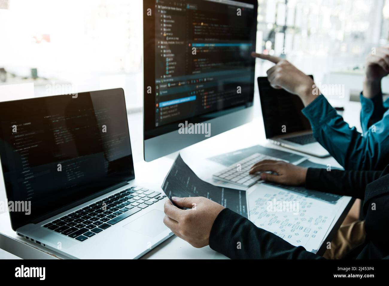 Two asian team working development of programming and encryption technology website design programmers on desk in office. Stock Photo