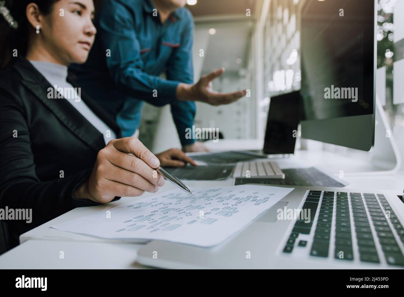 Two partnerships developing programming and coding technologies working on laptop and analyzing together. Stock Photo