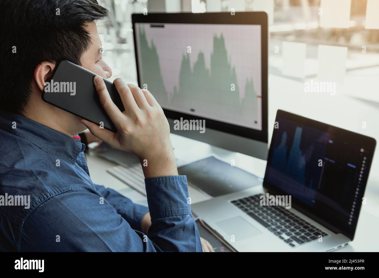 Two asian agent man working and analysis together in office market ...
