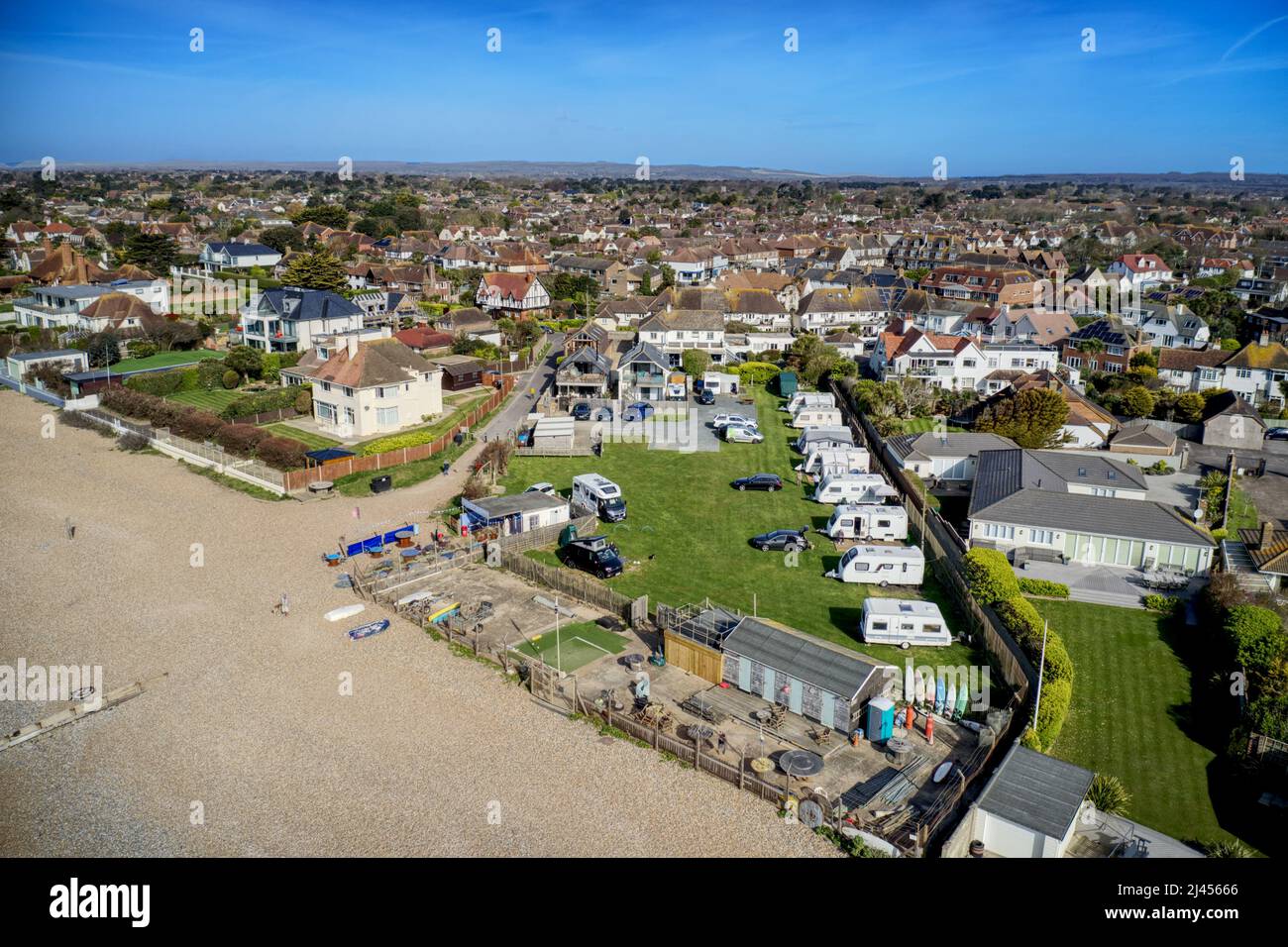 East Preston seafront village in West Sussex with the Coastal Camping site in view next to a cafe. Aerial Stock Photo