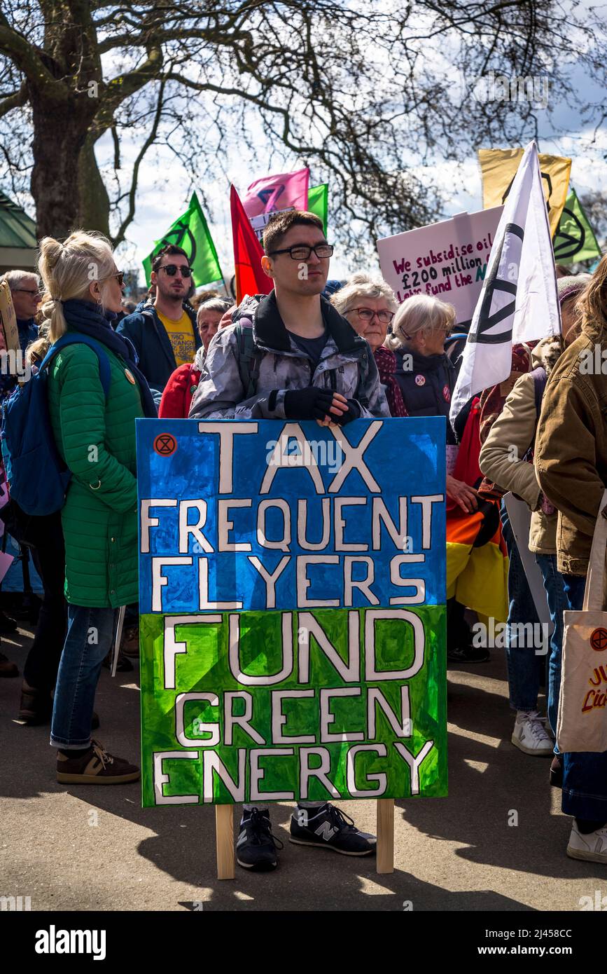 'Tax frequent flyers and fund green energy' placard at We Will Not Be Bystanders, an Extinction Rebellion protest that fights for climate justice, Hyd Stock Photo