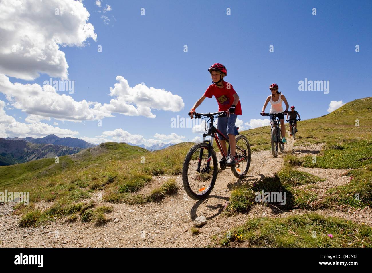 Montgenevre (French Alps, south-eastern France): bike ride, family riding mountain bikes in the upper part of the ski resort Stock Photo