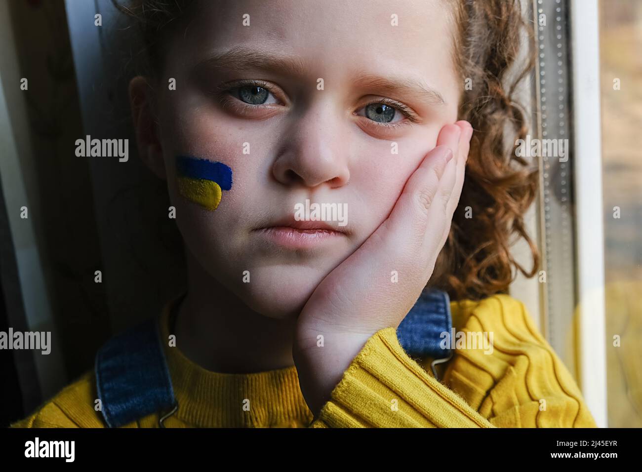 Premium Photo  Child girl sad profile face close up with hands on cheek.