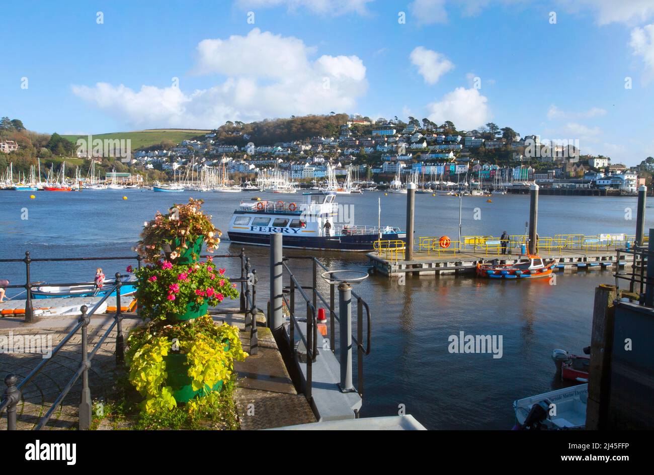 Passenger ferry approaching landing river Dart Dartmouth England UK copy space summer blue sky yachts & Kingswear houses in distance from Dartmouth Stock Photo