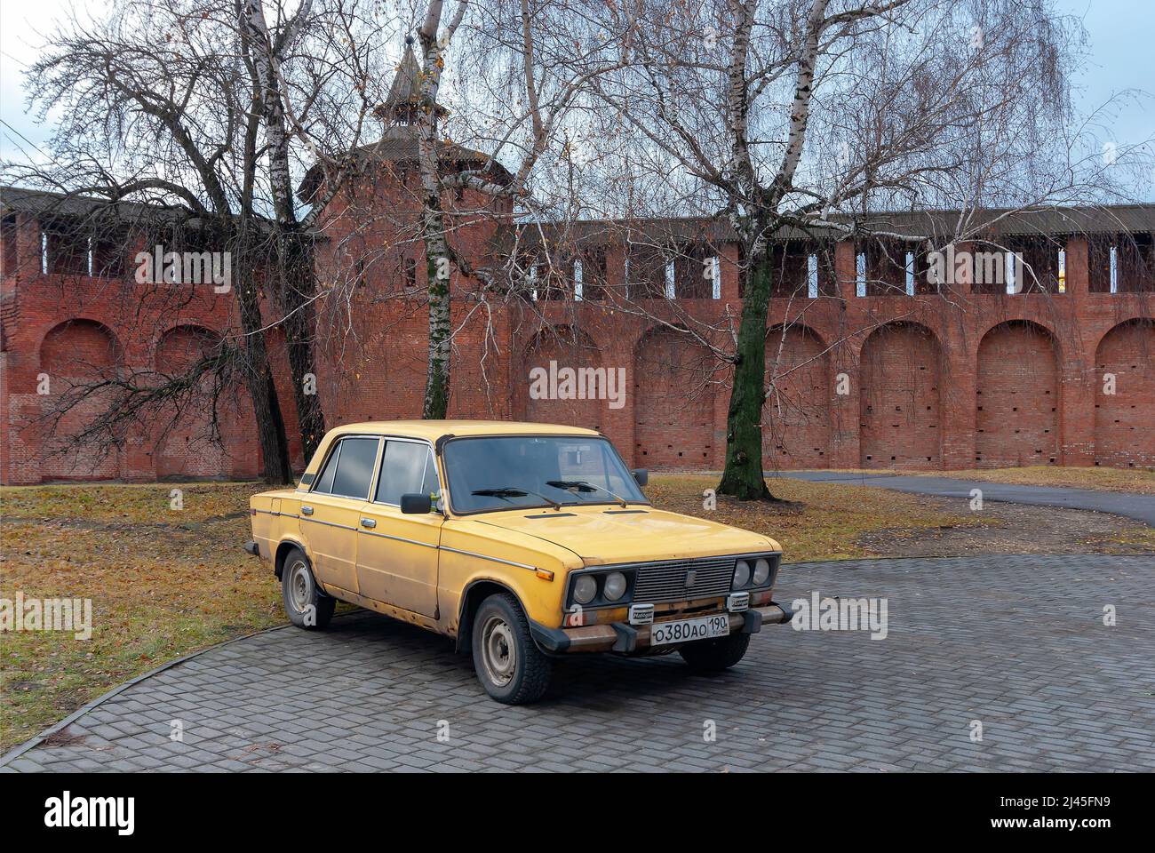 Passenger car VAZ-2106 (six) 'Zhiguli' yellow at the walls of Klomenskokreml Stock Photo