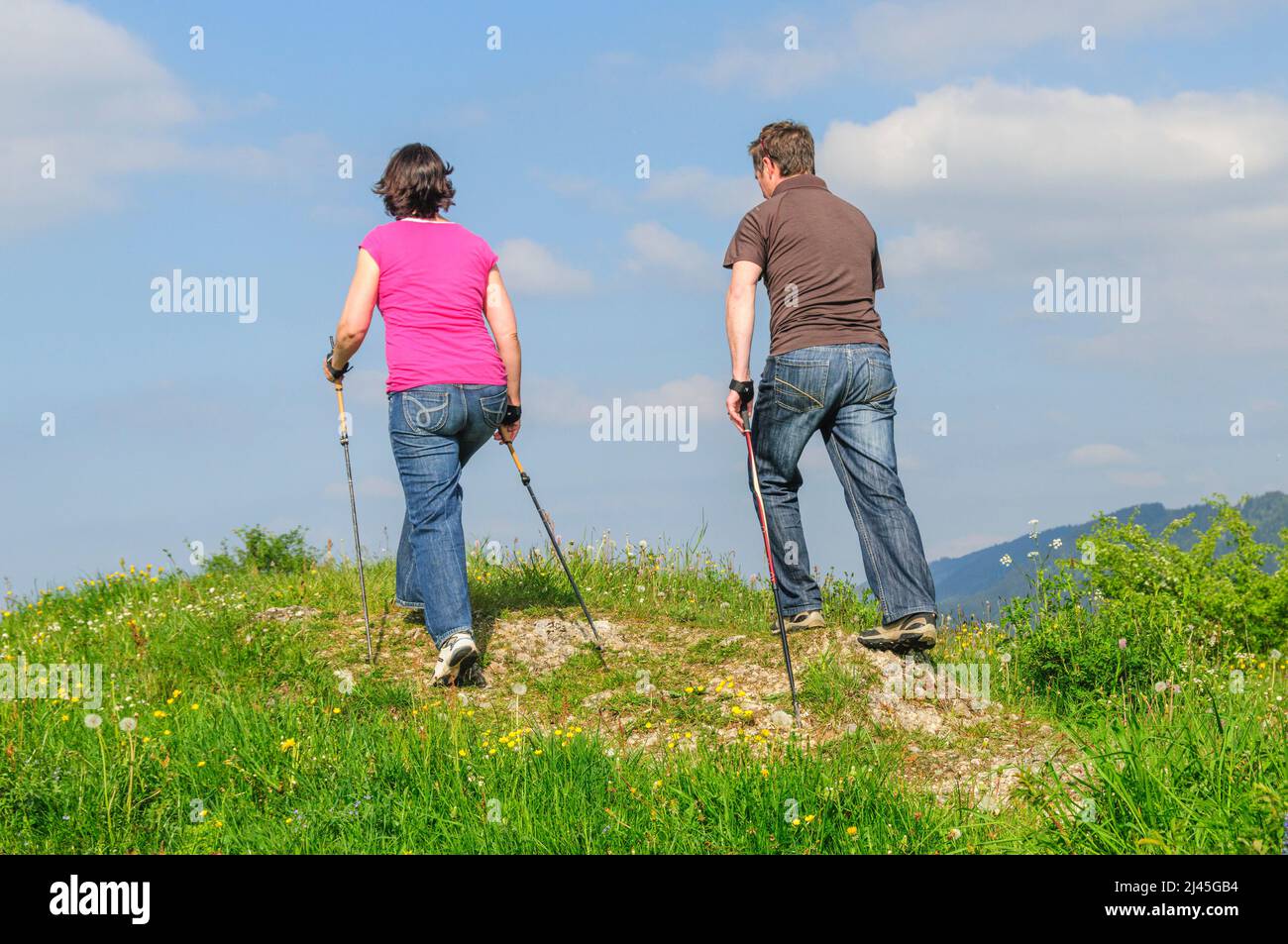 Man woman hiking walking poles hi-res stock photography and images - Alamy
