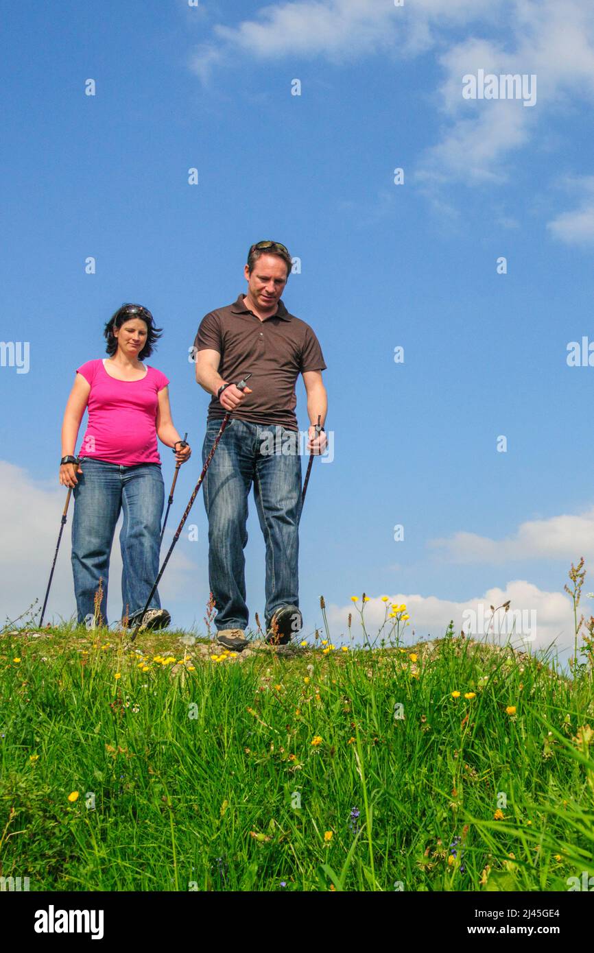 Relaxed Nordic Walking tour to the Dreiländerblick near Steibis, active together even during pregnancy Stock Photo