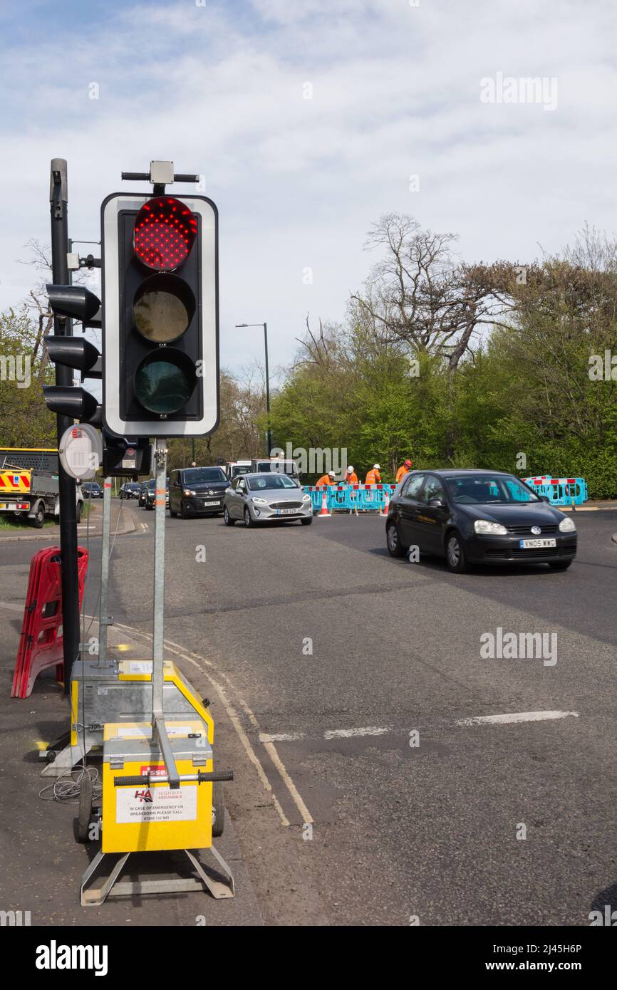 Roadworks and temporary traffic lights at the Mill Hill crossroads on Barnes Common in southwest London, England, UK Stock Photo
