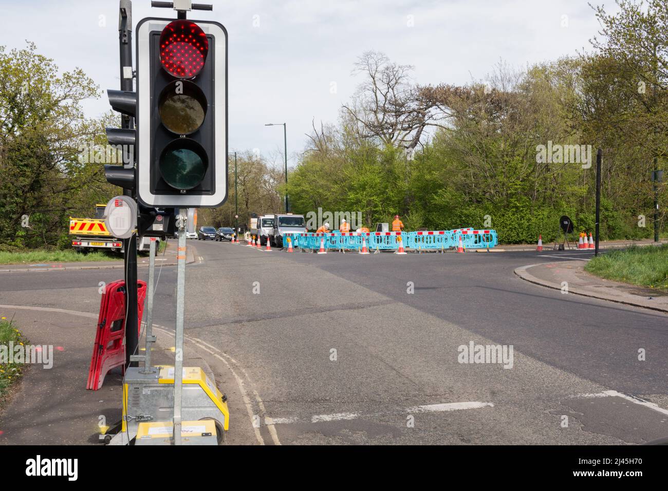 Roadworks and temporary traffic lights at the Mill Hill crossroads on Barnes Common in southwest London, England, UK Stock Photo