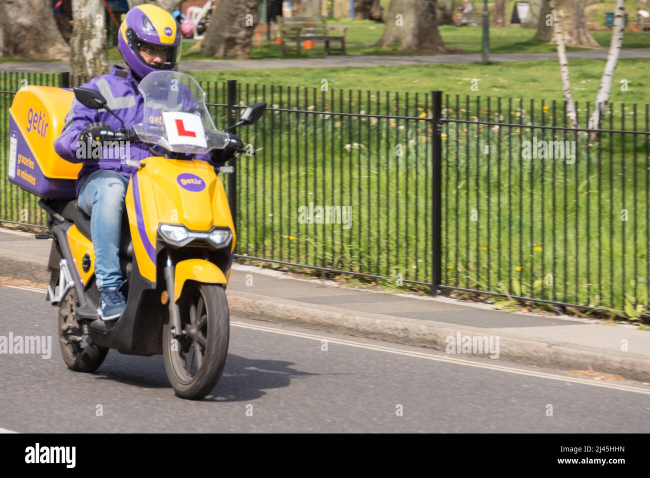 Getir ultrafast delivery driver delivering groceries on an e-scooter Stock Photo