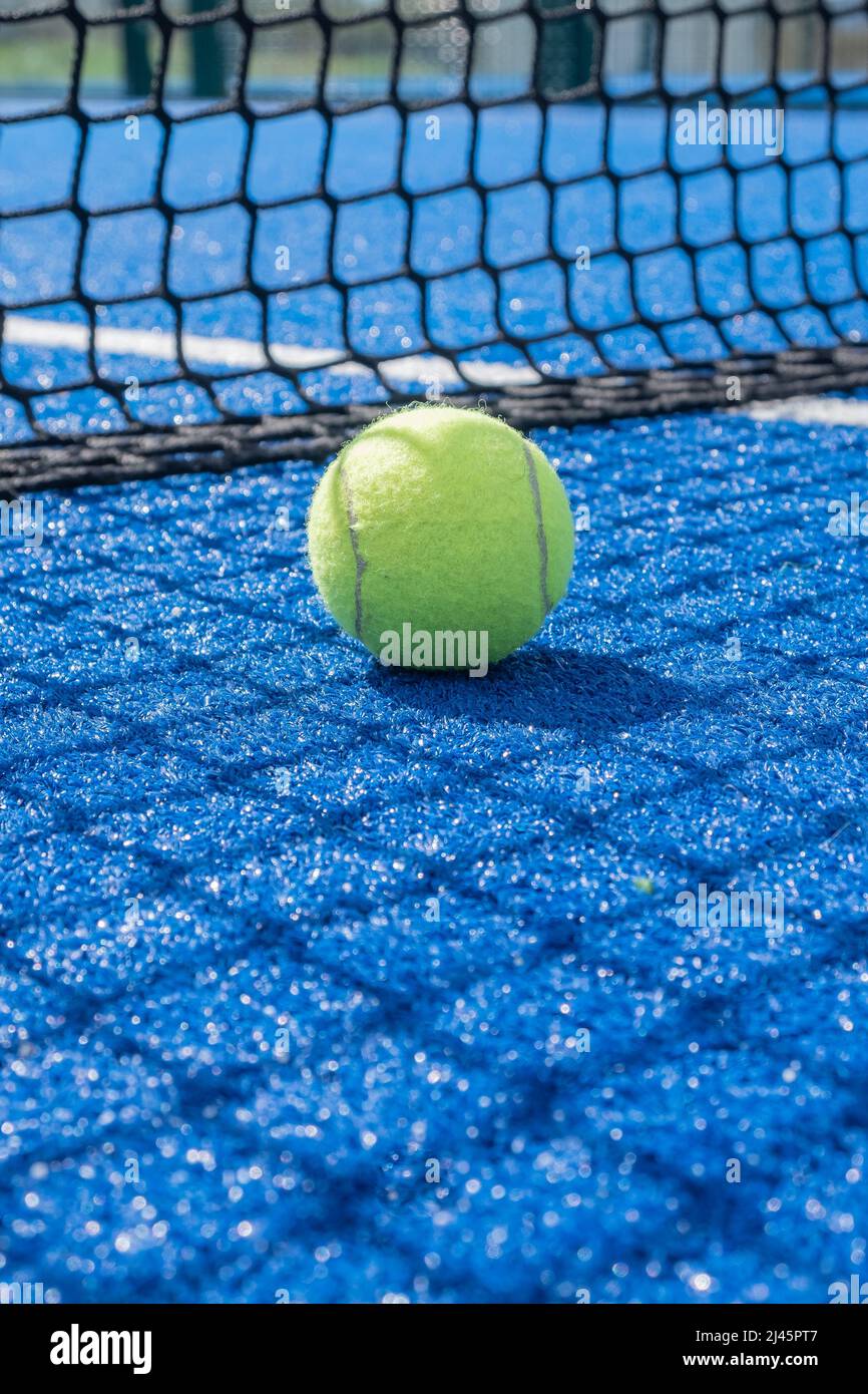 selective focus, paddle tennis balls on a blue paddle tennis court close to the net Stock Photo