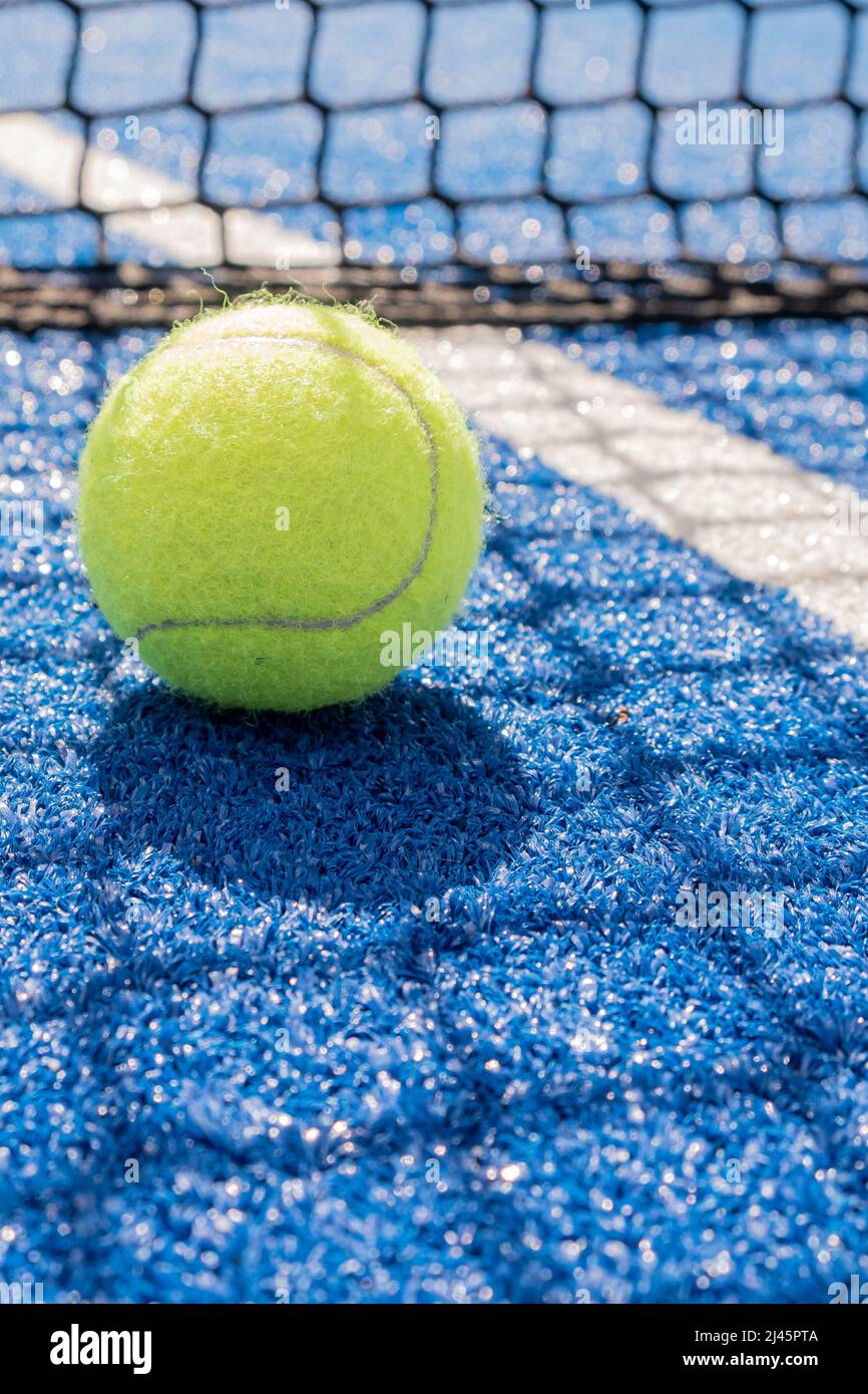selective focus, paddle tennis balls on a blue paddle tennis court close to the net Stock Photo